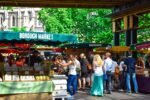 Lively scene at Borough Market in London, filled with people shopping and enjoying the atmosphere.